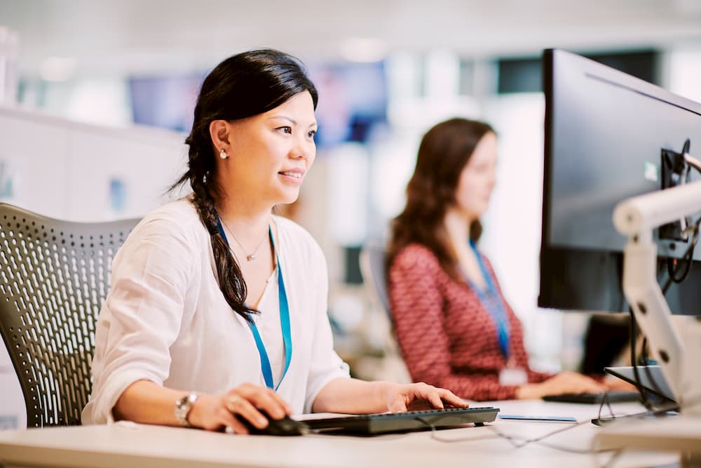Woman at a desk using a computer