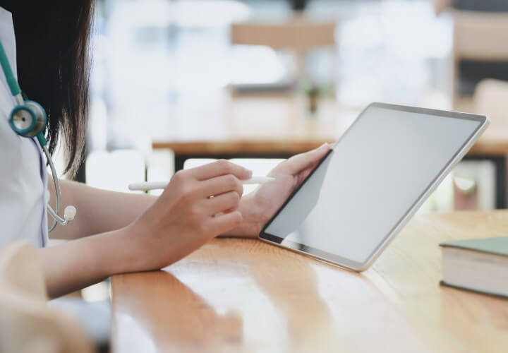 Picture of a woman working on an Ipad