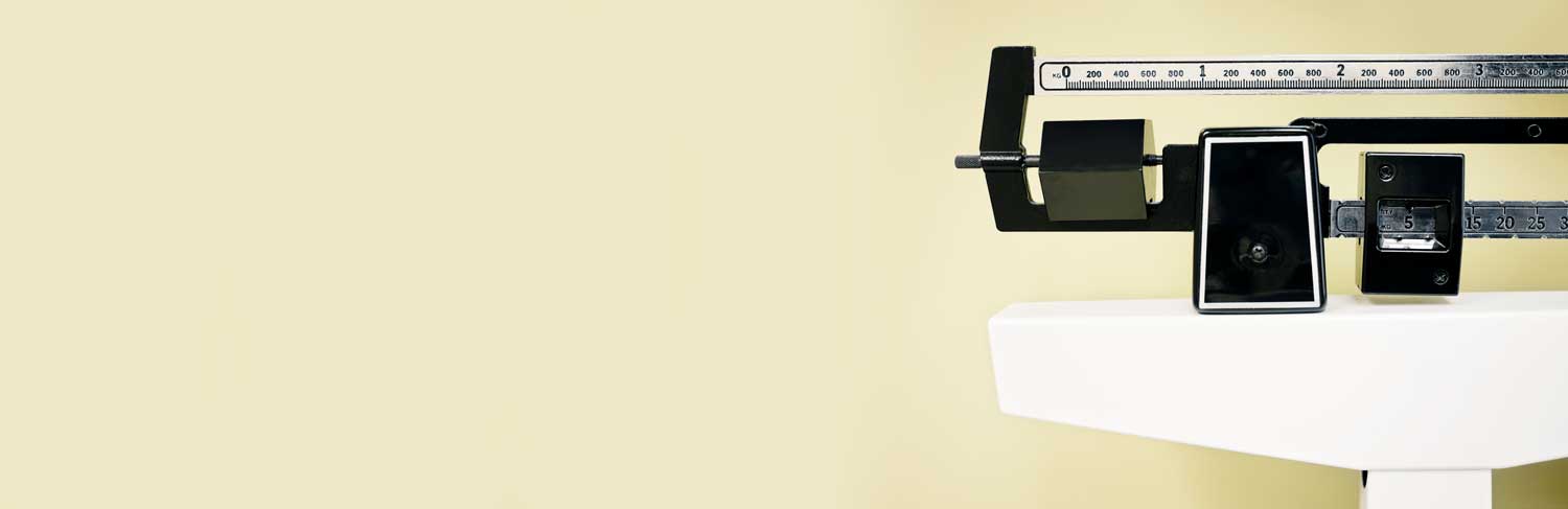 Picture of a medical scale on a yellow background