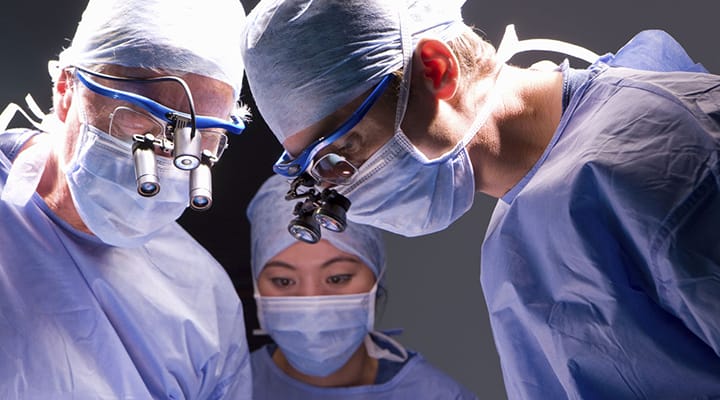 Picture of multiple doctors during surgery