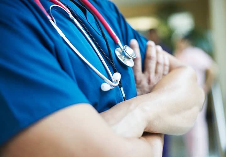 Picture of a doctor with his arms folded