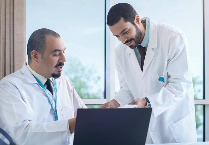 Doctors looking at a computer