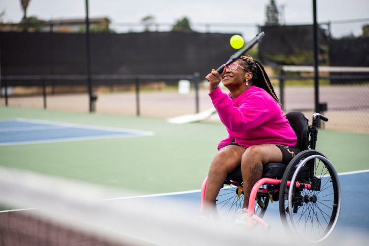 Picture of a woman in a wheelchair playing tennis