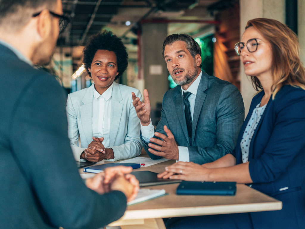 A group of professionals in the formal meeting
