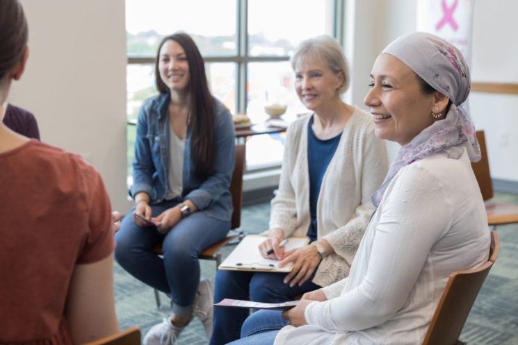 Picture of multiple women smiling at a support group