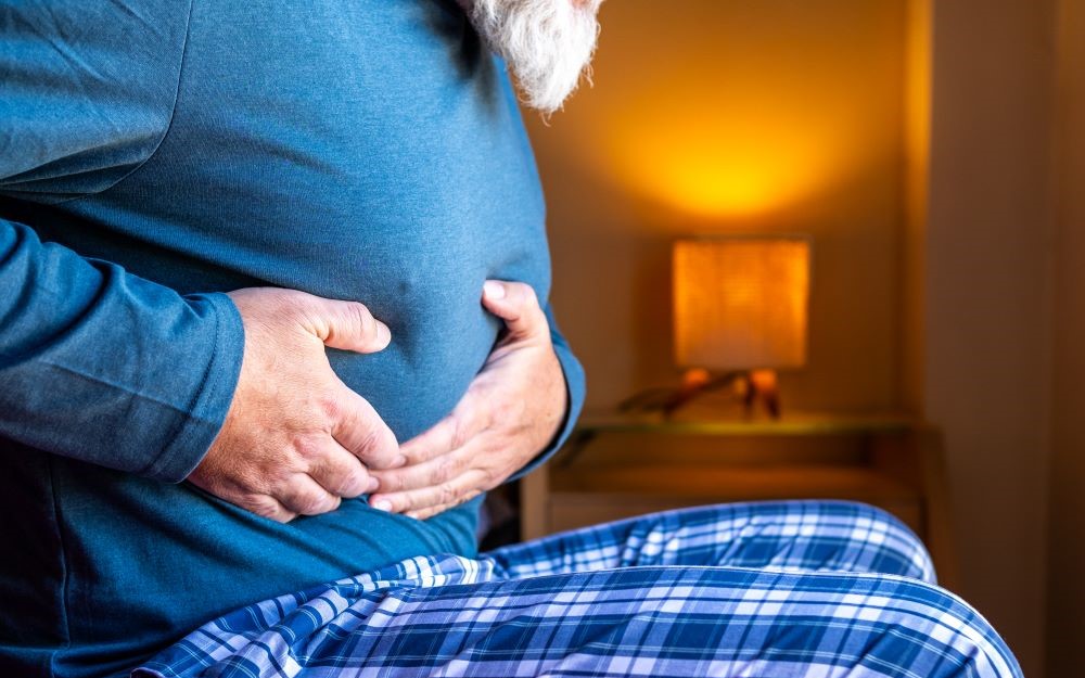 Picture of an older man with stomach ache