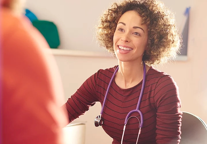 GP smiling at a patient