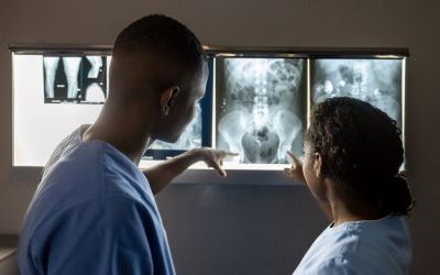 Radiographers examining an X-ray scan