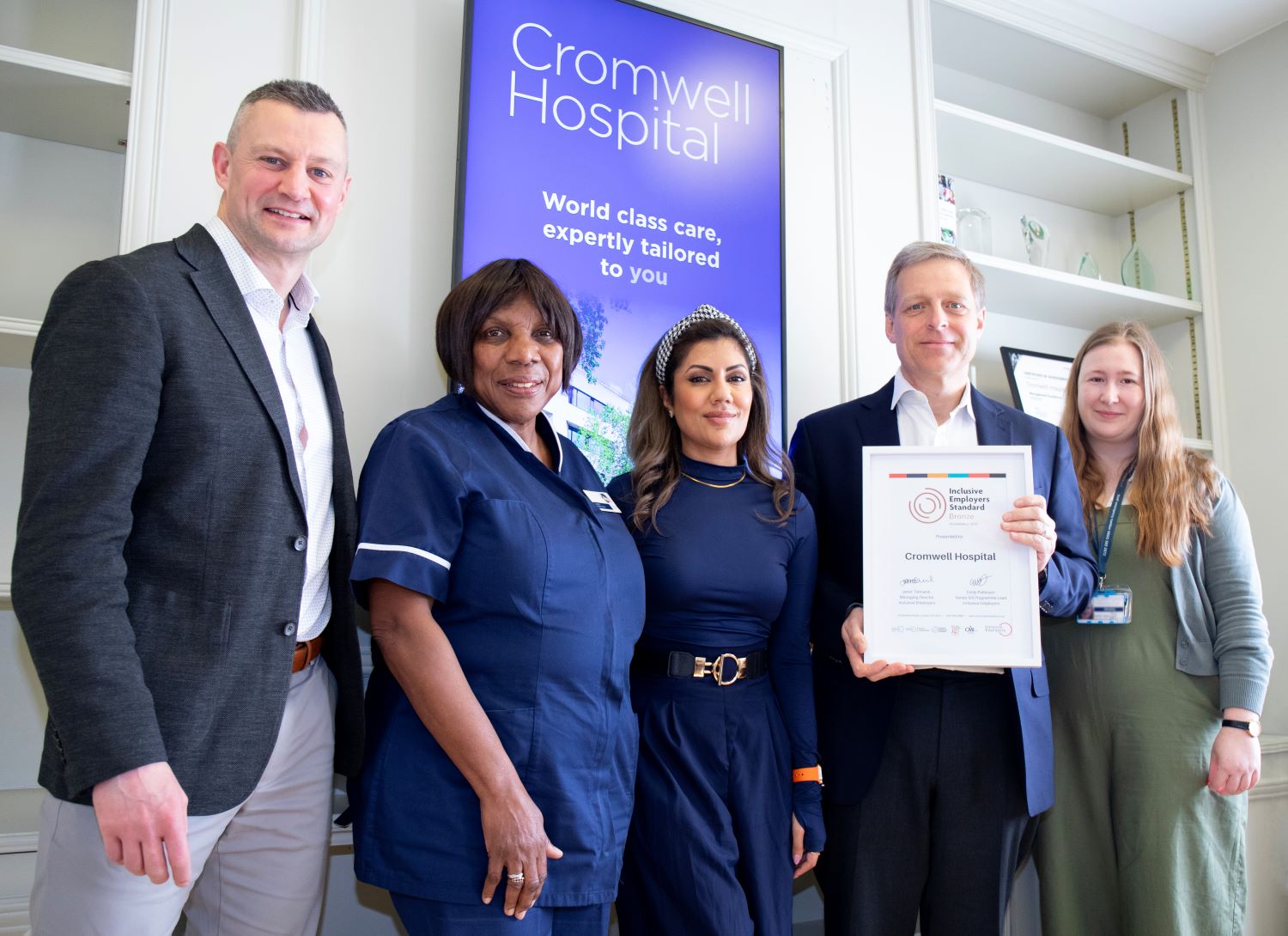 Hospital colleagues pose with the Inclusive Employers Standard certificate
