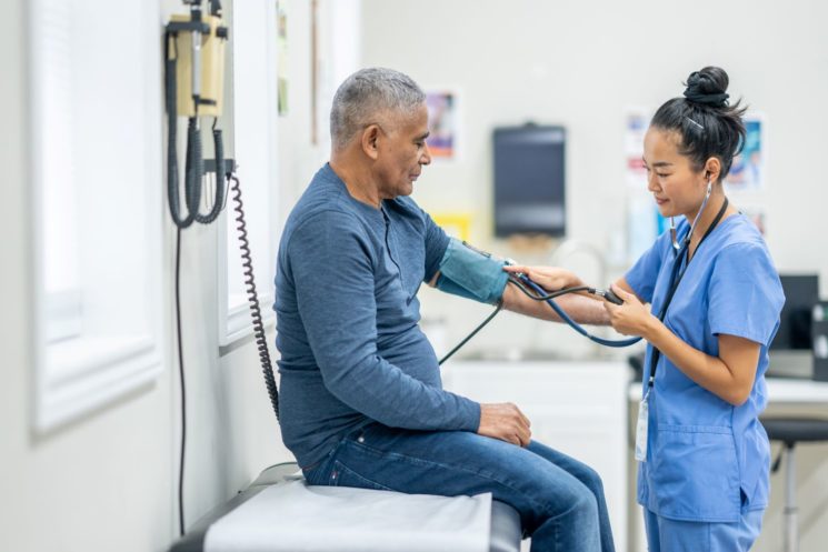 Male patient having his blood pressure checked by nurse