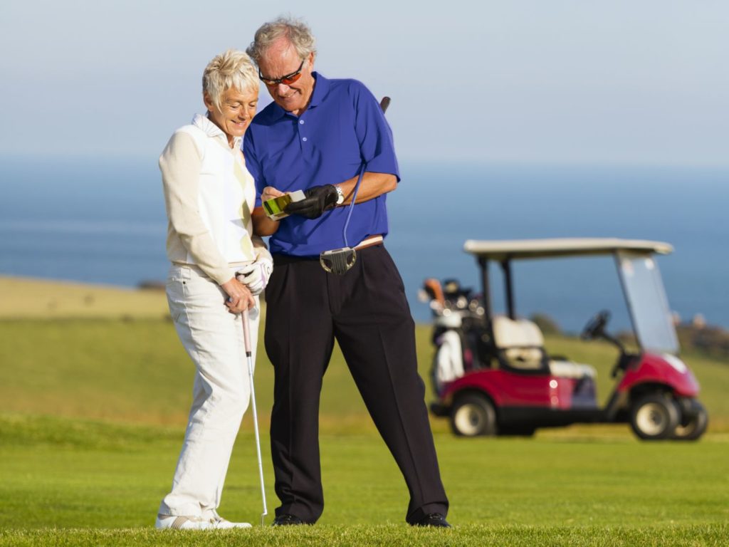A man and woman standing on a golf course
